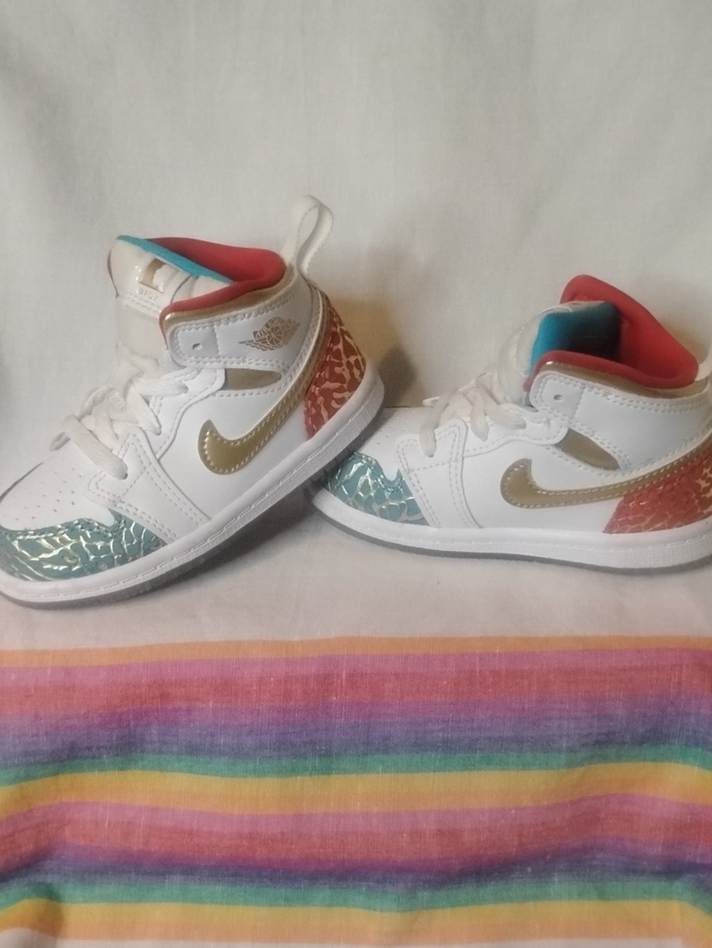 Nike Kids White Shoes with Gold Swoosh and Teal & Coral Accents